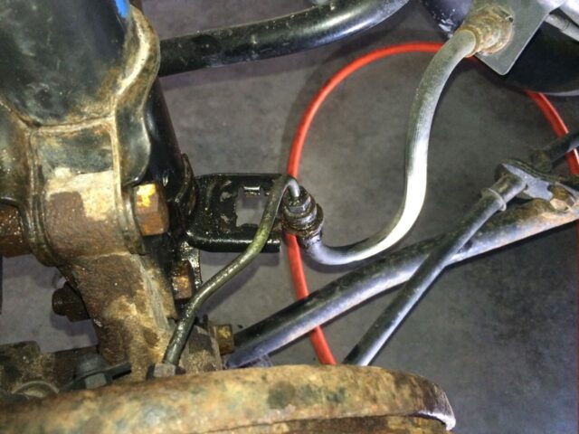 Brake line moved out of strut tab bracket