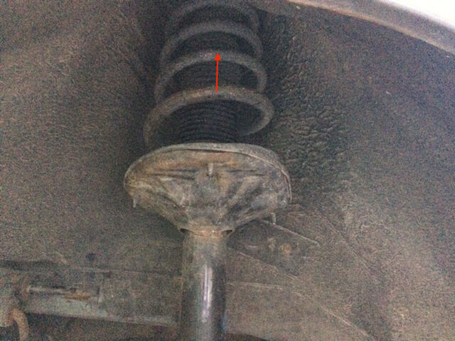 Slightly compress the strut spring