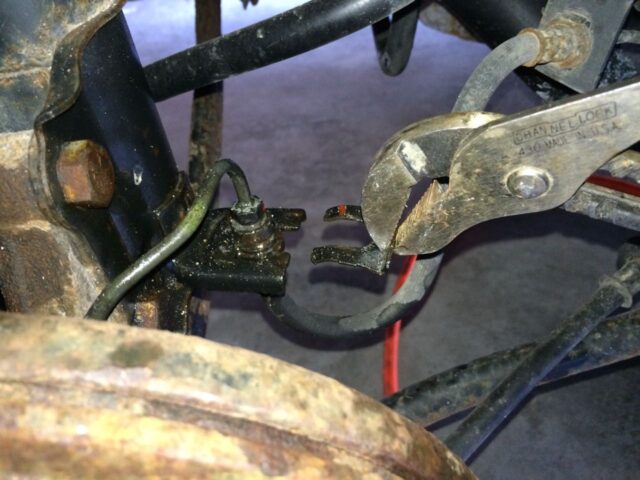 Brake line spring clip removed