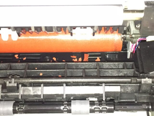 Orange chips falling off the fuser roller