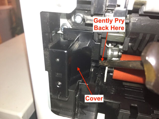 Diagram showing how to pry out the left plastic cover