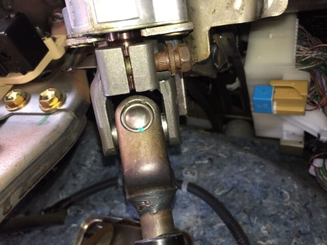 Close-Up of the top steering Intermediate Shaft Bolt Being Reinstalled