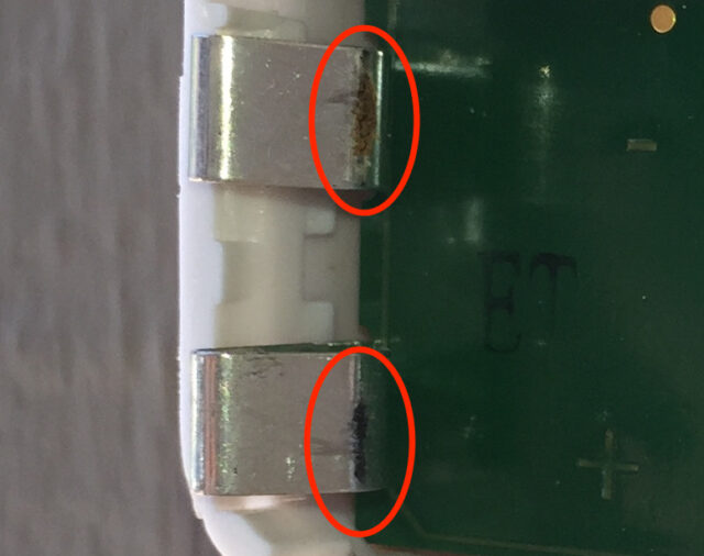 A close-up of the battery contact corrosion