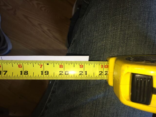 Measuring the strip of paper with a tape measure