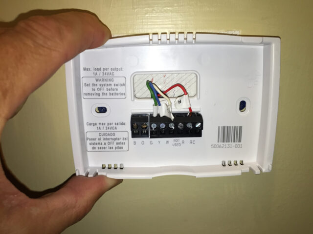 Line up the mounting plate with the wall anchors