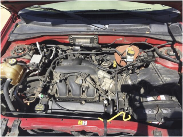 The engine bay before cleaning