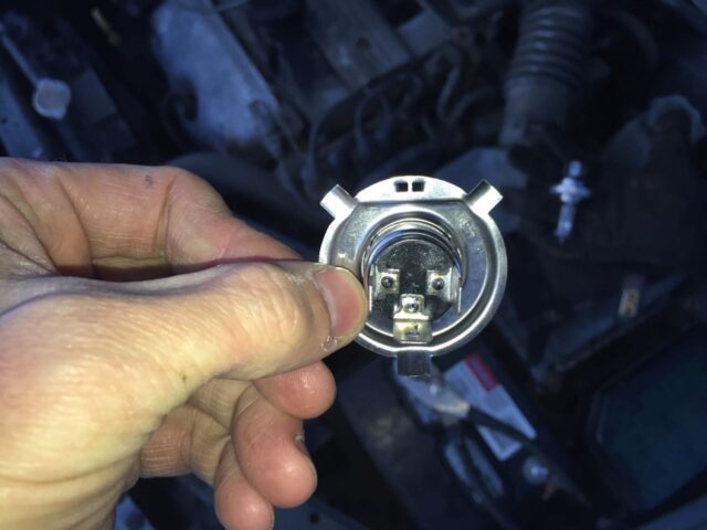 Burnt out headlight bulb removed
