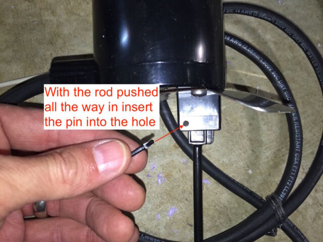 Inserting the locking pin into the float switch