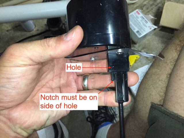 Illustration of how to insert the float rod into the switch body