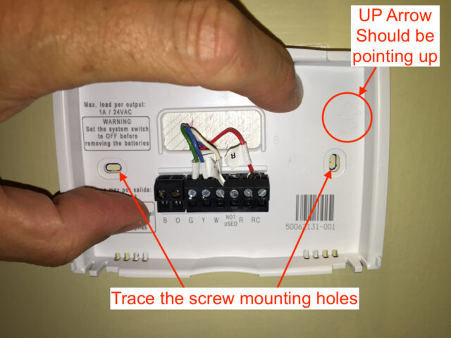 Marking the holes on the wall for drilling