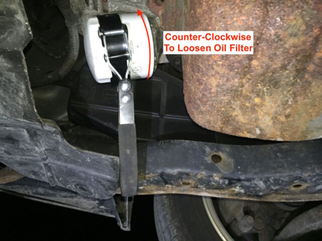 Removing the oil filter with a filter wrench