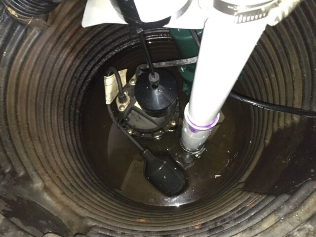 Top view of installed backup sump pump float assembly