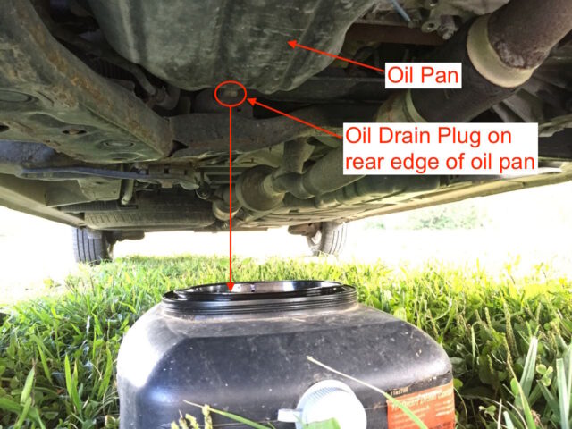 Oil pan below oil drain plug