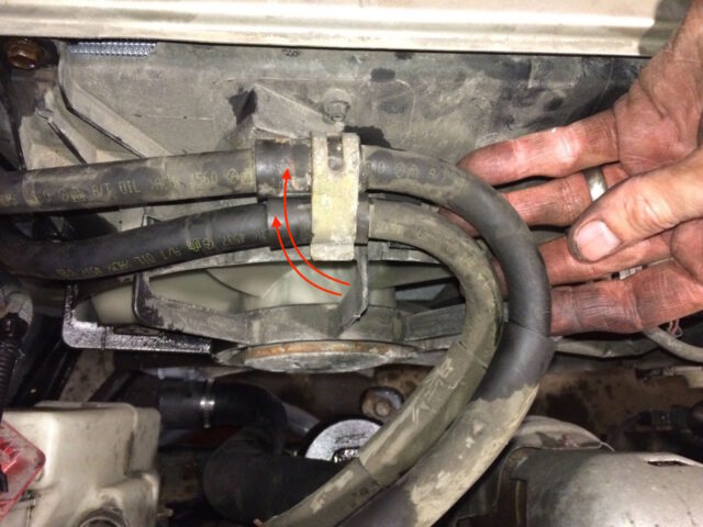 Reinstalling the oil cooler lines under their retainer