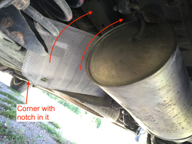 Instructions for sliding the heat shield back up on top of the muffler