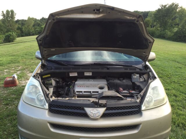 Toyota Sienna with hood propped up