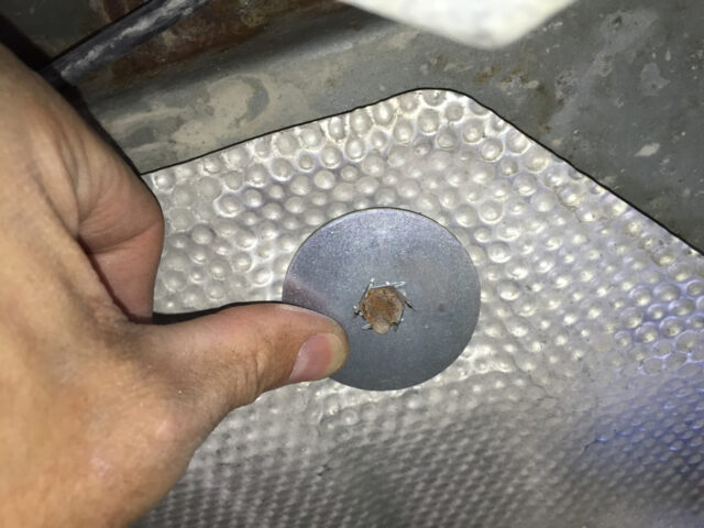 The modified washer fits perfectly over the rusted nut